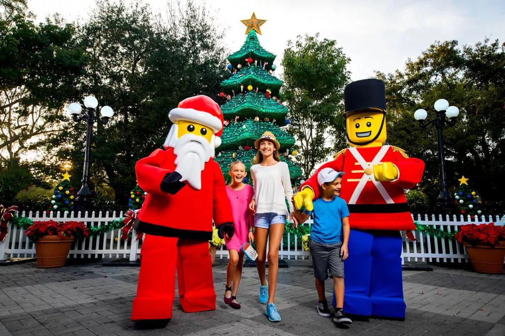 Christmas at LEGOLAND Florida Three children posing in front of a LEGO Christmas tree with LEGO santa and a toy soldier
