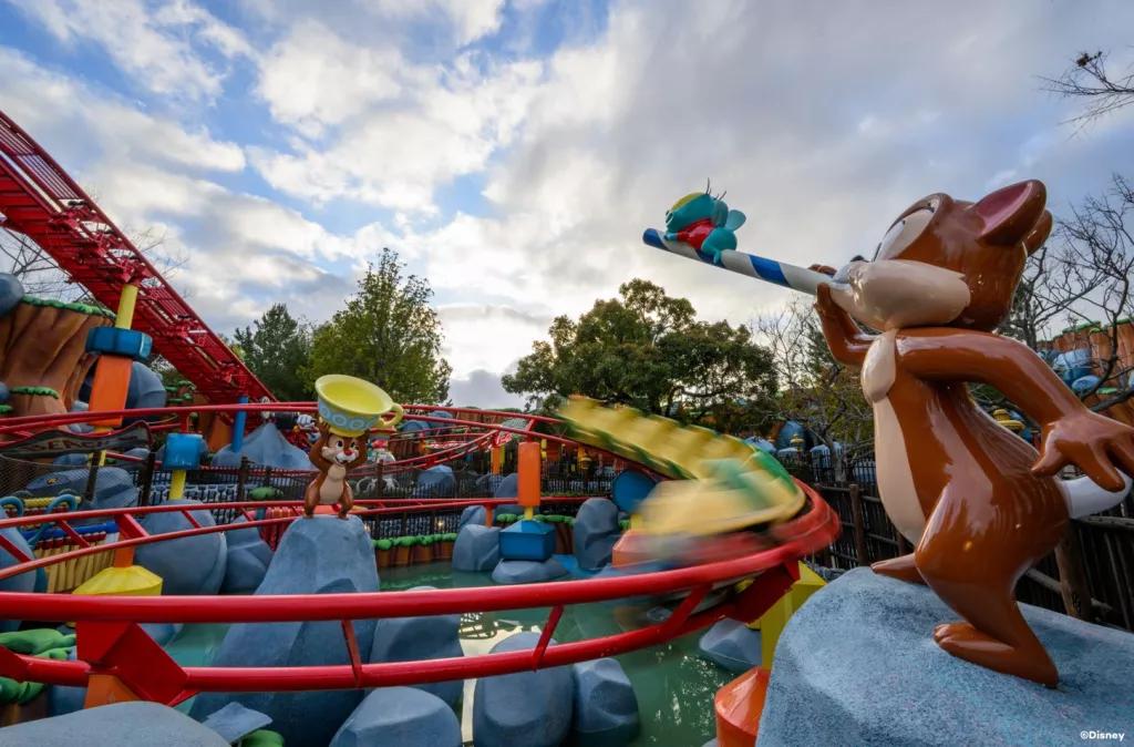 Chip 'n' Dale's GADGETcoaster A rollercoaster train going round a red track next to models of Chip and Dale