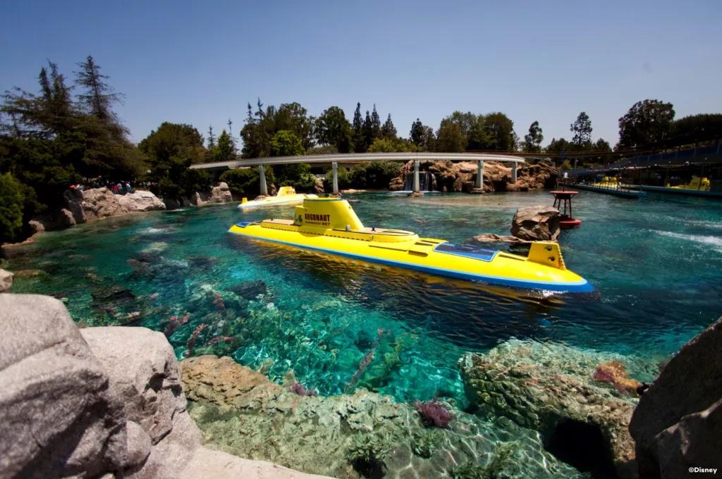 Finding Nemo Submarine Voyage A bright yellow submarine on the surface of a lagoon with clear blue water