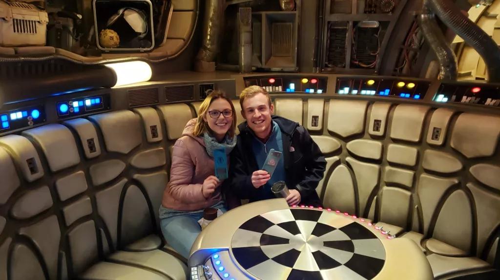 Millenium Falcon: Smugglers Run A man and woman sat at a round table designed to look like it is on a spaceship