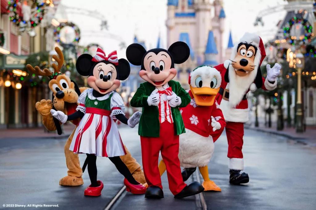 Christmas at Walt Disney World Mickey Mouse, Minnie Mouse and their friends standing on Main Street USA in their Christmas outfits