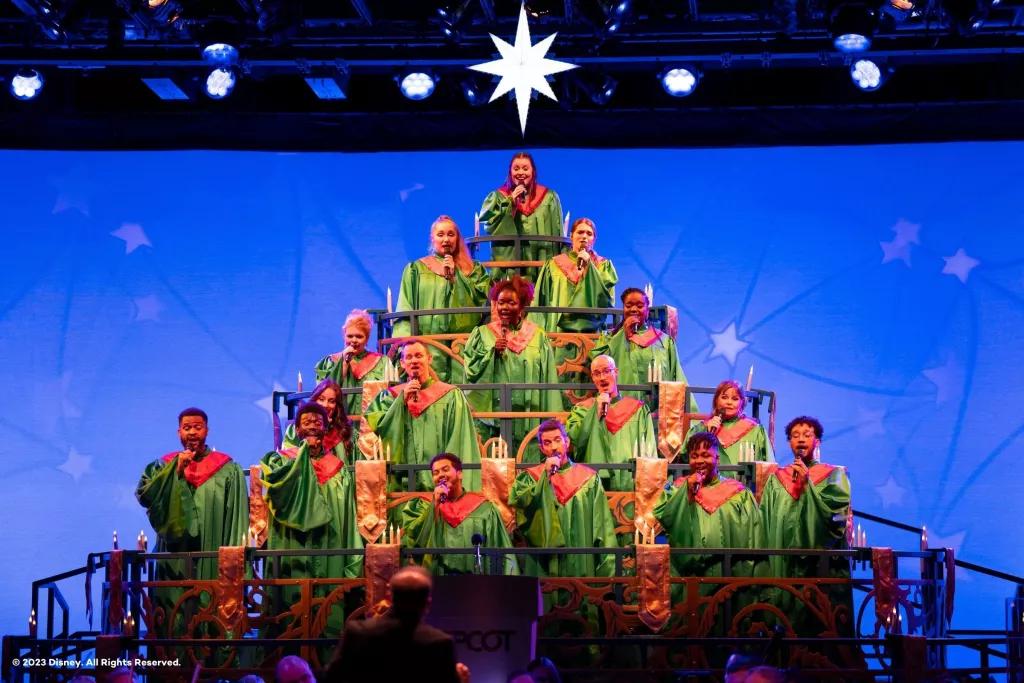 Candlelight Processional A choir dressed in green robes standing in a pyramid formation to look like a Christmas tree
