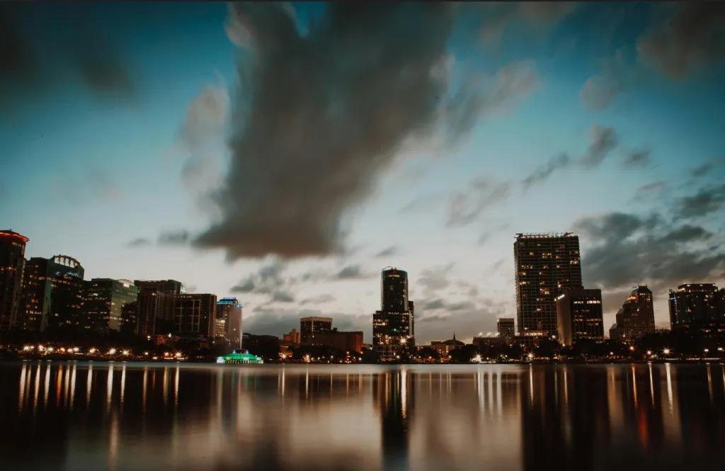 Lake Eola A lake leading up to a city skyline with the sun setting in the background