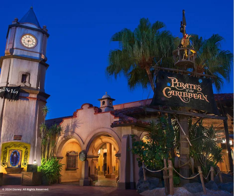 Pirates of the Caribbean ride in the Magic Kingdom Park Sign shaped like a pirate sail with the name of the ride outside of Pirates of the Caribbean