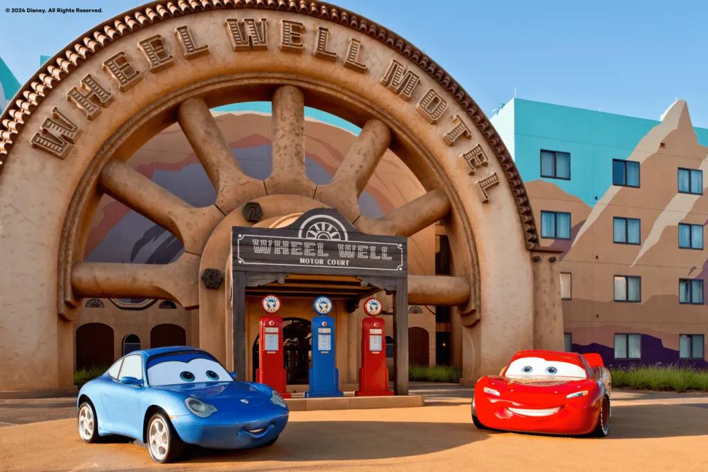 Disney's Art of Animation Resort Models of Lightning McQueen and Sally from Pixar's Cars in front of a hotel building