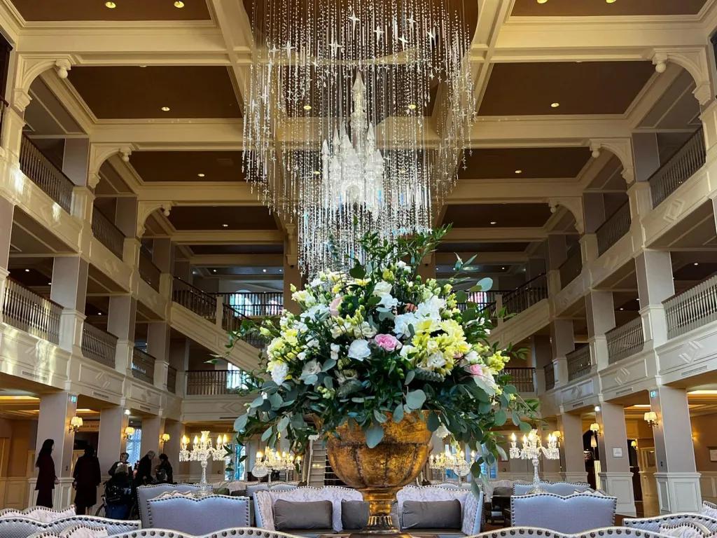 Disneyland Hotel Lobby A bouquet of flowers on a side table in a large hotel lobby with a