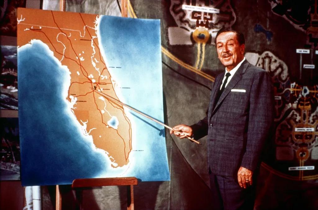 Walt Disney reveals Florida Project Walt Disney stood in front of colourful map of Florida with wooden stick to point for television broadcast.