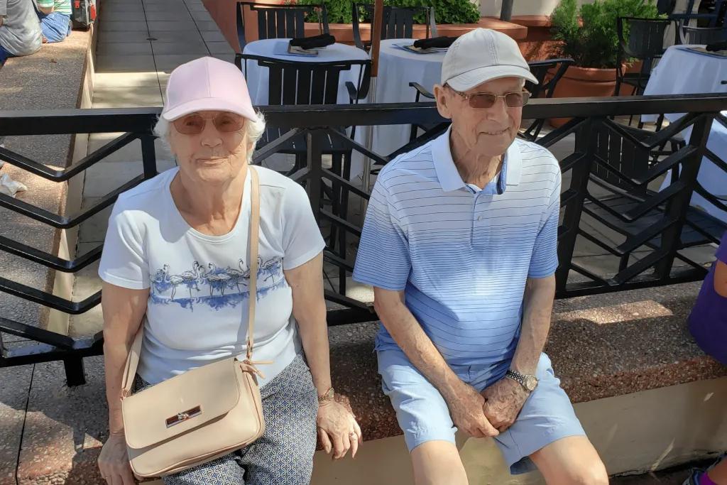 Disney's Hollywood Studios An older couple smiling at the camera while they sit on a low wall