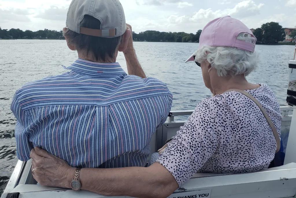 Winter Park Boat Tour An older couple on a boat tour. The woman's arm is around the man's back