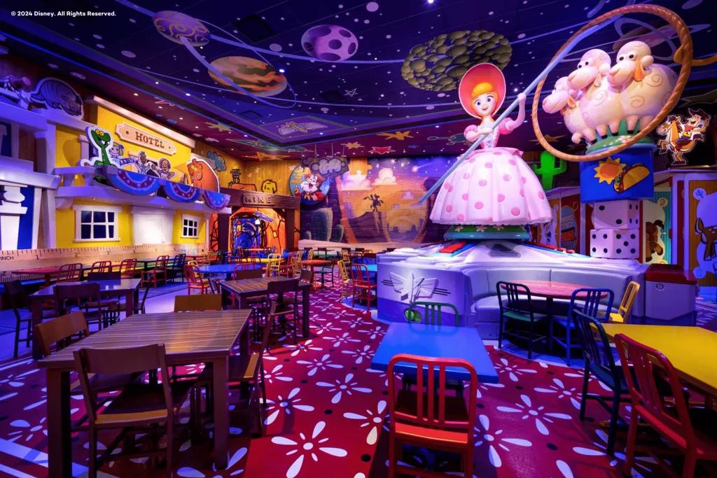 Roundup Rodeo BBQ An empty restaurant filled with tables and chairs surrounding a large statue of Bo Peep from Toy Story