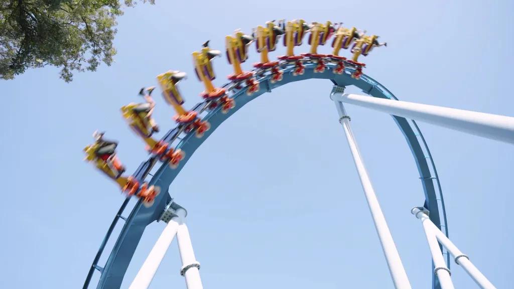 Phoenix Rising A rollercoaster going over an inversion against a clear blue sky