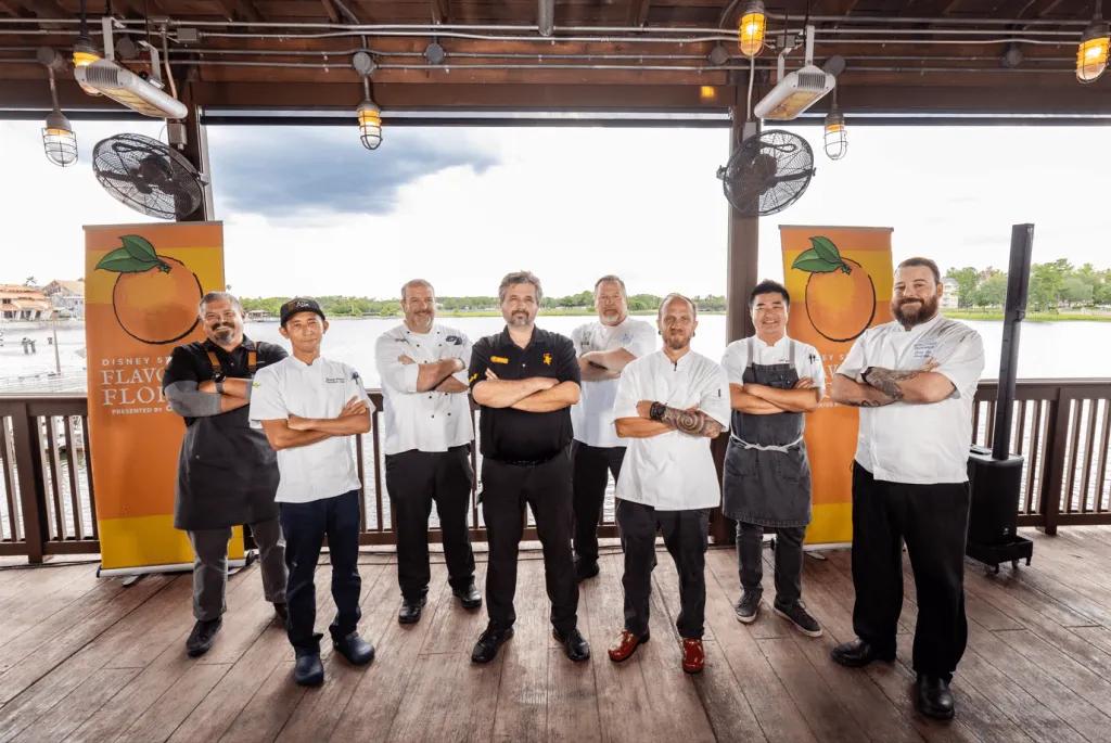 Flavours of Florida Cookery Demonstrations 9 chefs standing on a wooden stage facing the camera with their arms crossed