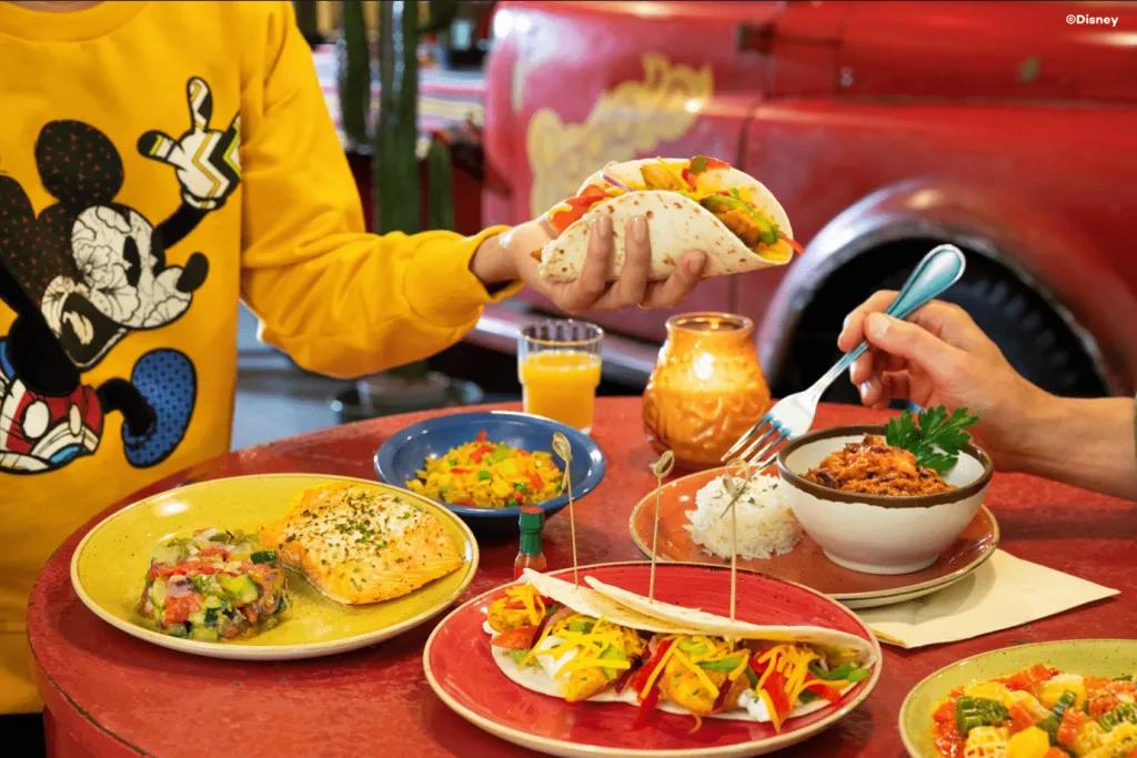La Cantina at Disney Hotel Santa Fe Two people reaching over a table covered in plates of Tex Mex food