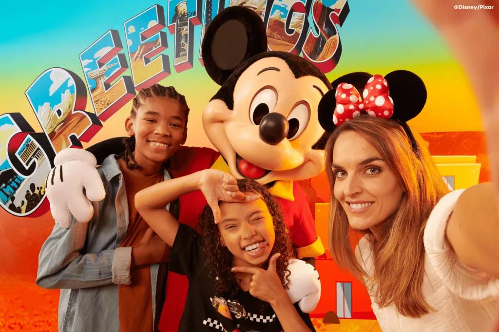 Character Meets at Disney Hotel Santa Fe A mum taking a selfie with her two children posing with Mickey Mouse in the background