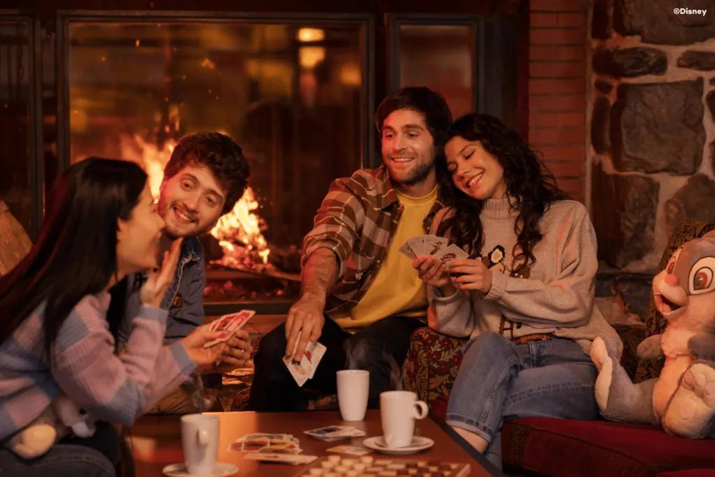 Redwood Bar and Lounge at Sequoia Lodge A group of friends say next to a fireplace playing cards around a table
