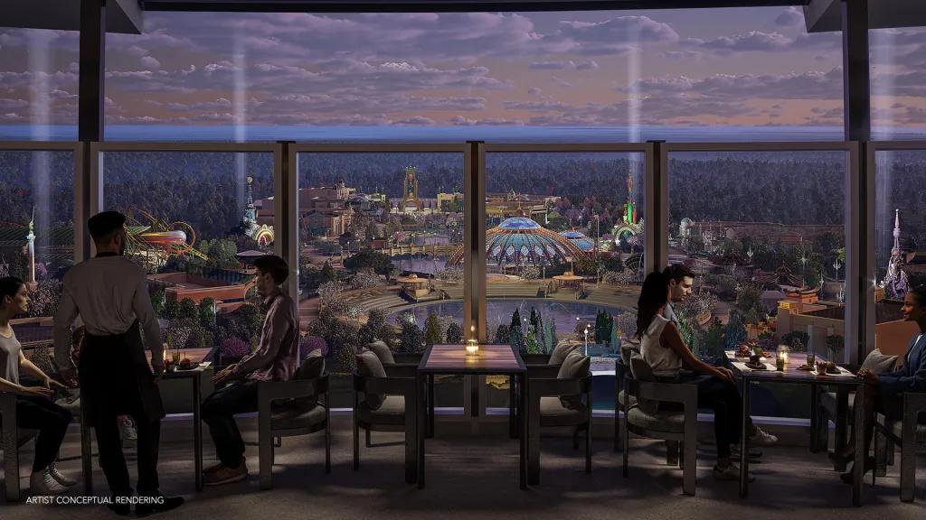 Bar Helios in Universal Helios Grand Hotel A circular rooftop bar offering 360 degree views of Epic Universe. There are people sat at candlelit tables by the edge of a glass window. There are also two white lights shooting up into the sky in the background.