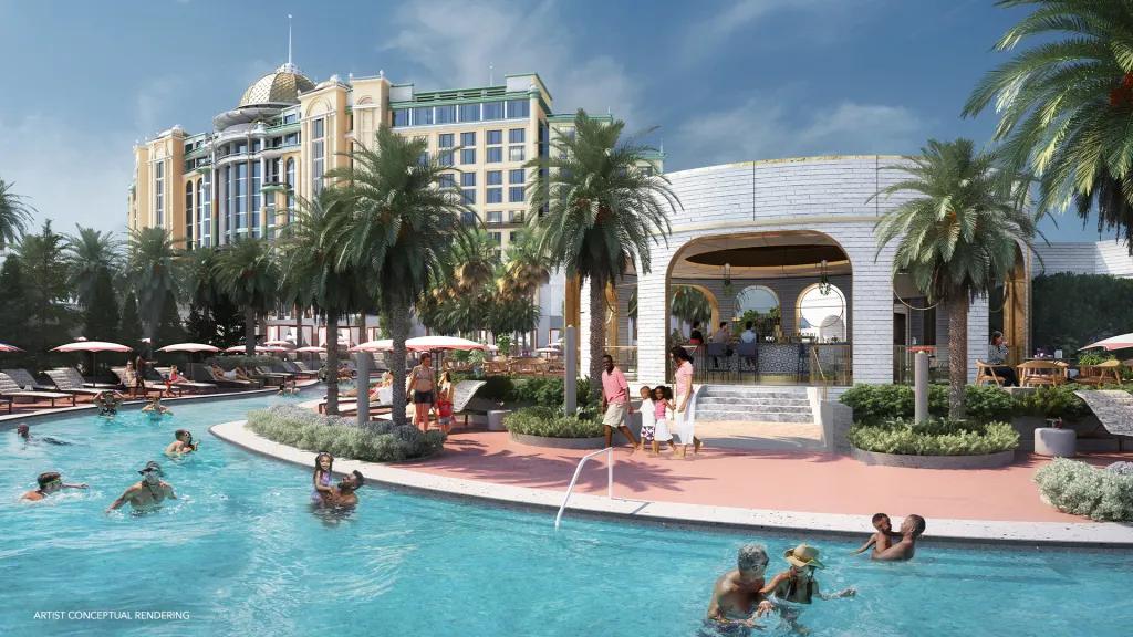 Lotus Lagoon and pool in Universal Helios Grand Hotel A large, clear water pool with many families and people swimming in it. Next to the pool there is a circular shaped building with a bar inside. In the background there is a large white hotel.