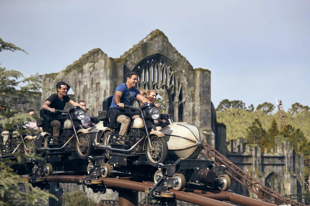 Hagrid's Magical Creatures Motorbike Adventure People riding a rollercoaster designed to look like a motorbike and side car