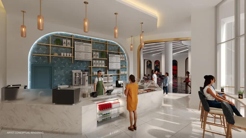 Aurora Market in Universal Helios Grand Hotel Modern Mediterranean style cafe with white counters, gold lighting, a glass case with desserts in. People are sat on gold seats looking outside windows overlooking Epic Universe.