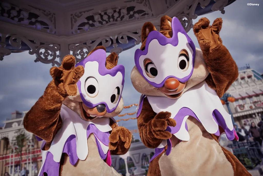 Halloween Character Encounters Chip and Dale posing for the camera wearing white and purple Halloween masks