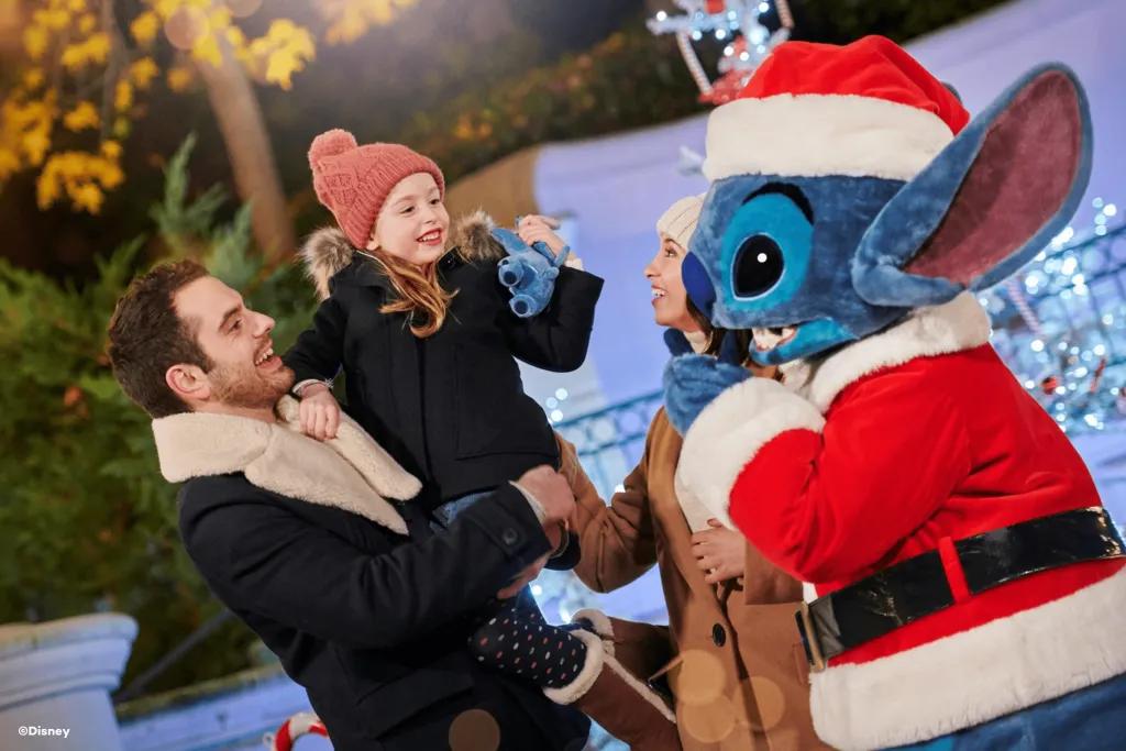 Christmas Character Encounters at Disneyland Paris A family with a young girl meeting Stitch wearing a Santa costume