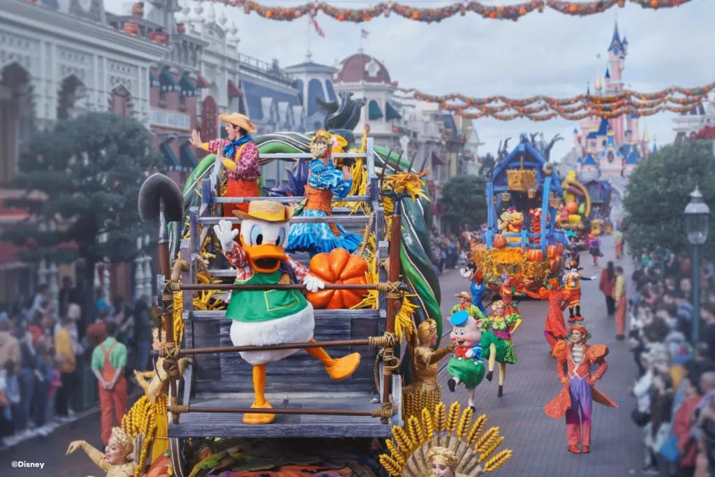Mickey's Halloween Celebration at Disneyland Paris Donald Duck in a farmer costume leading a parade of floats coming down Main Street USA