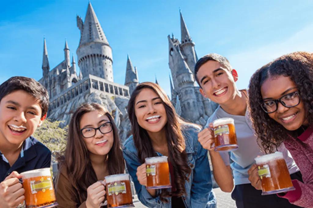 Butterbeer at The Wizarding World of Harry Potter A group of friends drinking Butterbeer in front of Hogwarts Castle