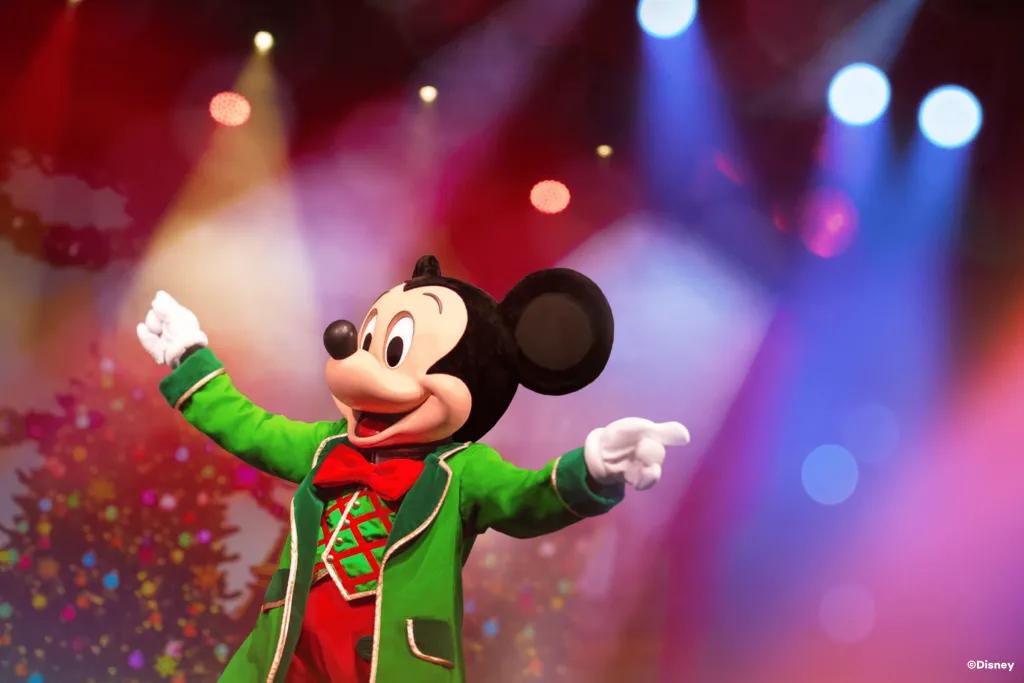 Let's Sing Christmas at Disneyland Paris Mickey Mouse in a festive outfit holding out his hands as if conducting an orchestra