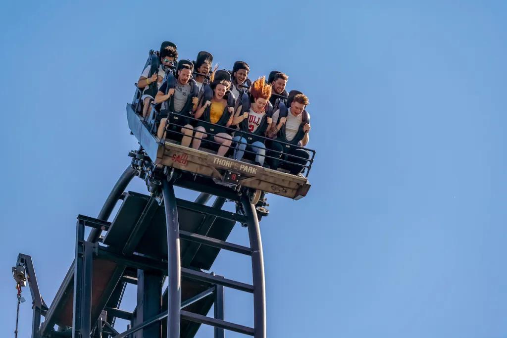 SAW - The Ride at Thorpe Park People in a ride car at the top of a rollercoaster drop