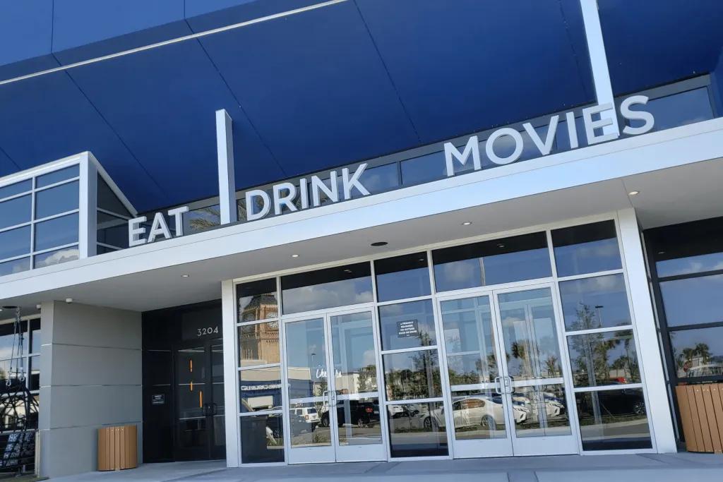 Studio Movie Grill The entrance to a building with 'Eat, Drink, Movies' above the door