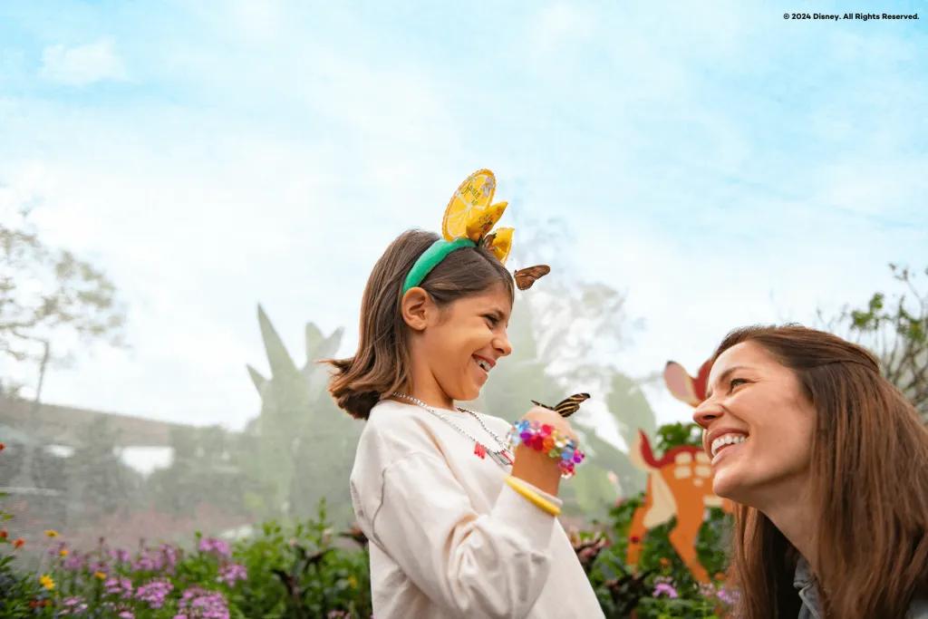 EPCOT International Flower & Garden Festival A woman laughing with a young girl who has had two butterflies land on her