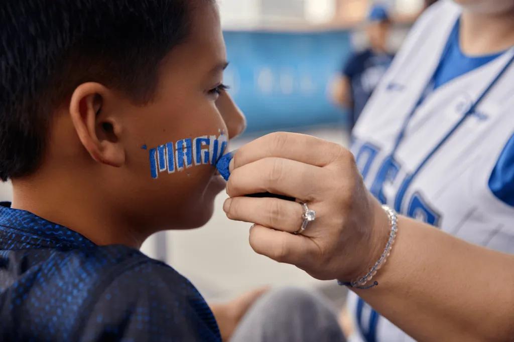 Orlando Magic Fan Fest A young boy getting his face painted with the Orlando Magic logo