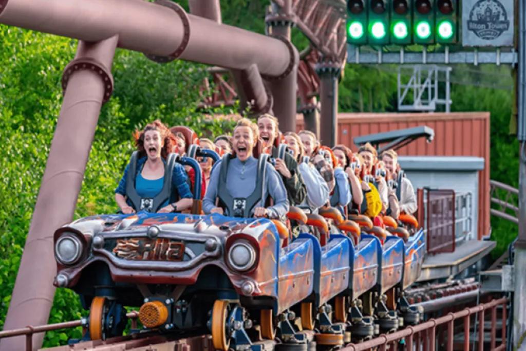 Rita at Alton Towers Rollercoaster shaped like a car speeding down launch with traffic light's lit green above.
