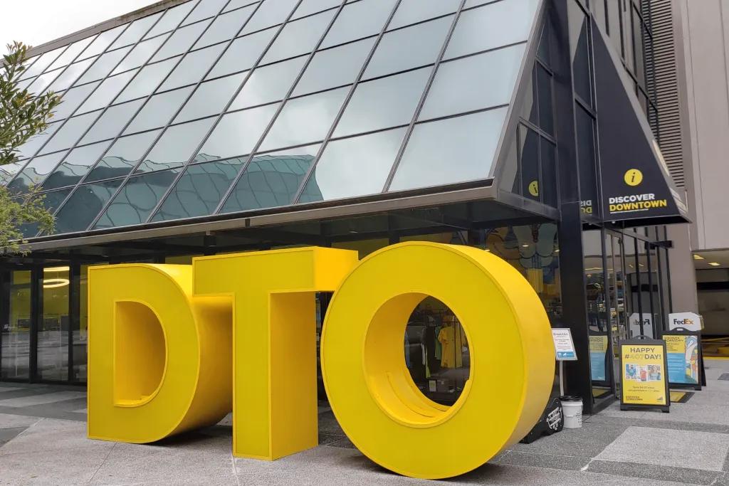 Discover Downtown visitor centre Glass building with a giant yellow DTO sign outside.
