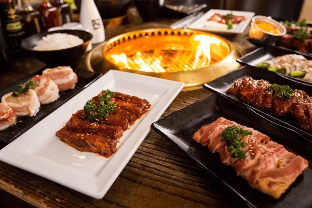 Dining in Orlando Small firepit in centre of table with plates of food surrounding it.