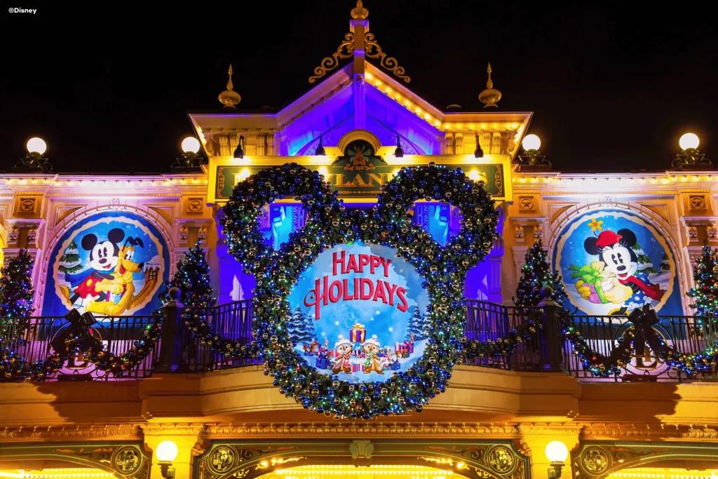 Disneyland Paris Christmas Decorations A Christmas wreath in the shape of Mickey Mouse around a sign reading Happy Holidays