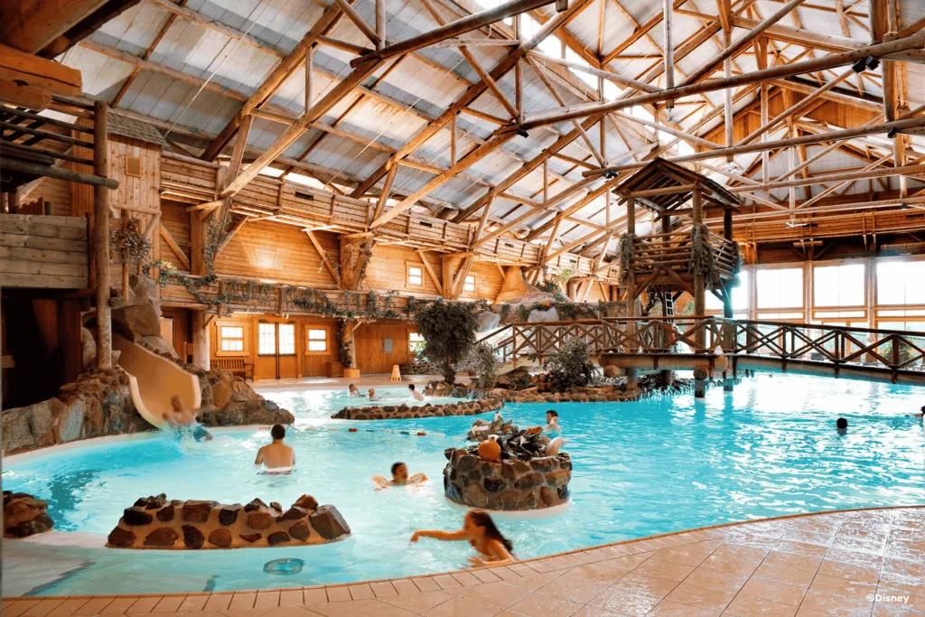 Disney Davy Crockett Ranch Pool A large indoor pool with a slide