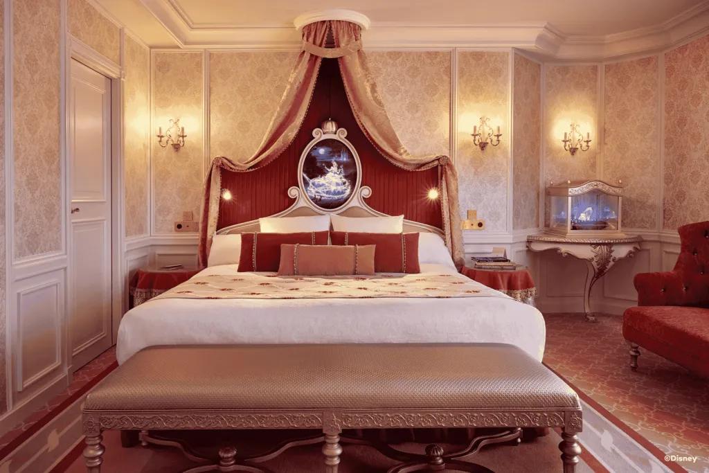 Cinderella Suite at the Disneyland Hotel in Disneyland Paris A Cinderella themed hotel room with a king-sized canopy bed and a glass slipper in a case