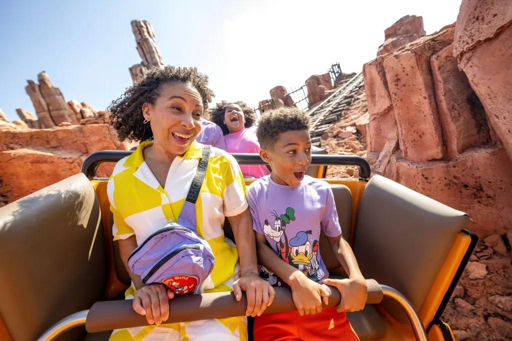 A boy and woman riding a rollercoaster