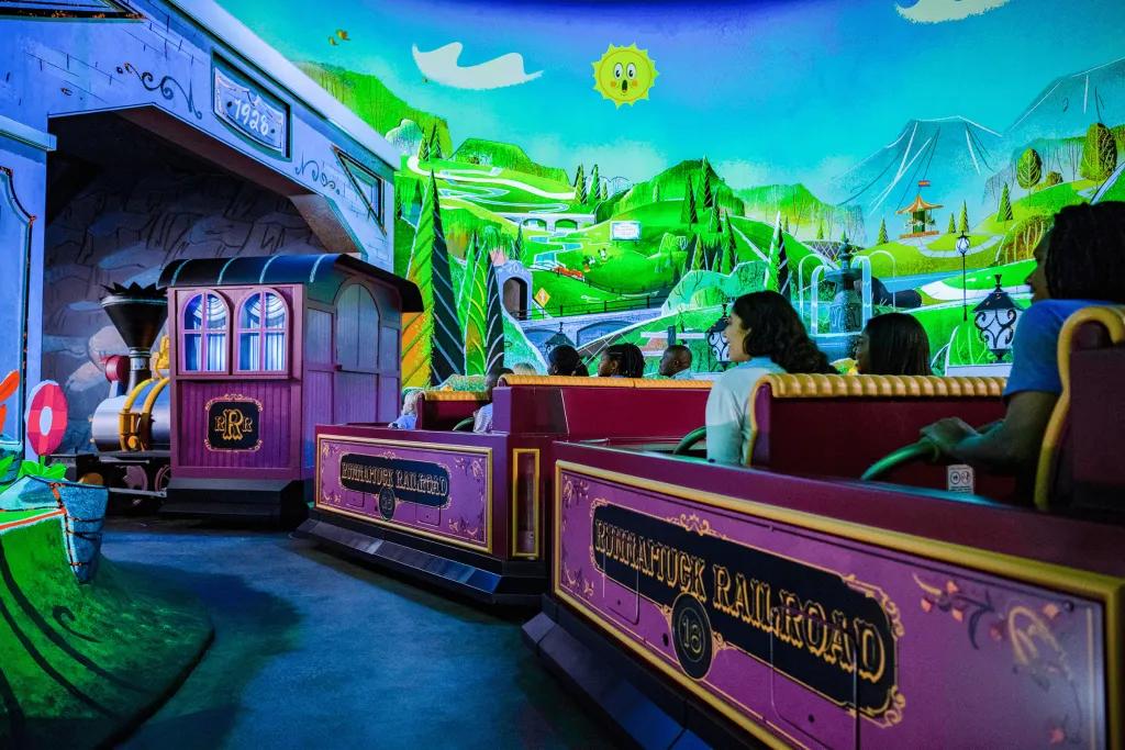Mickey & Minnie's Runaway Railway A train shaped ride with rows of four going through a cartoon world.