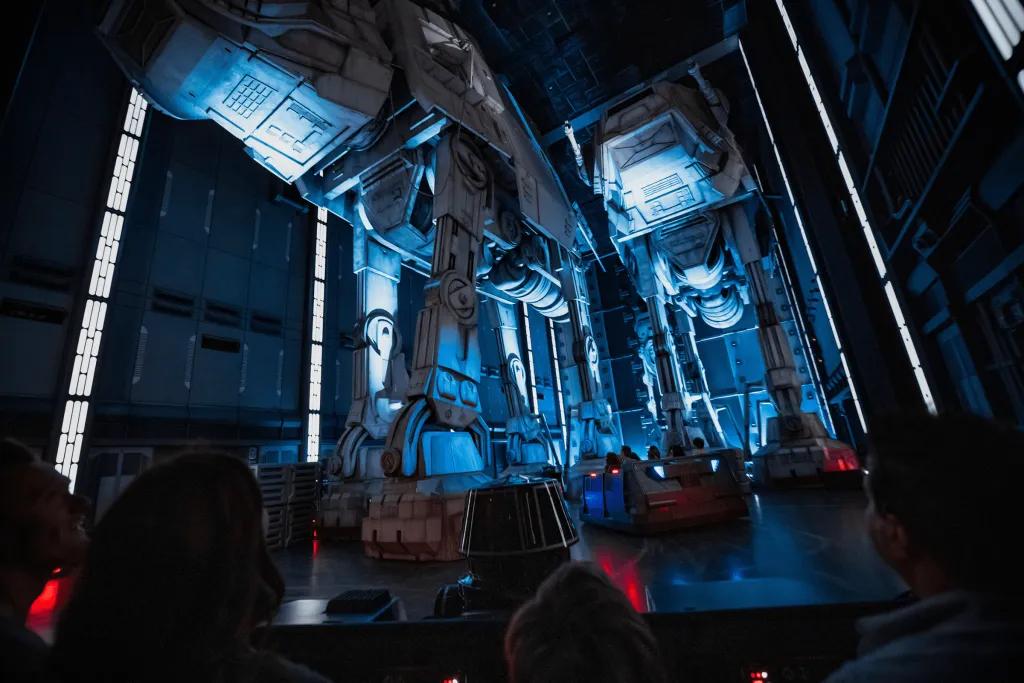Star Wars: Rise of the Resistance There are large robots with four legs and storm troopers sat inside. The rollercoaster carts are small with two rows of four and a robot sat in the front.