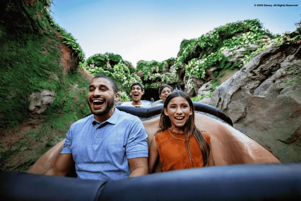 Tiana's Bayou Adventure A man and young girl smiling while going down the drop on a log flume