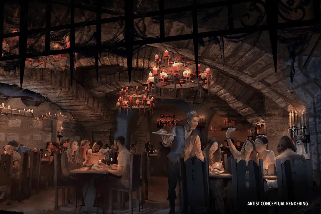 Das Stakehaus at Dark Universe A dark lit restaurant with a castle style with a spikey gate lifted up and old lights.