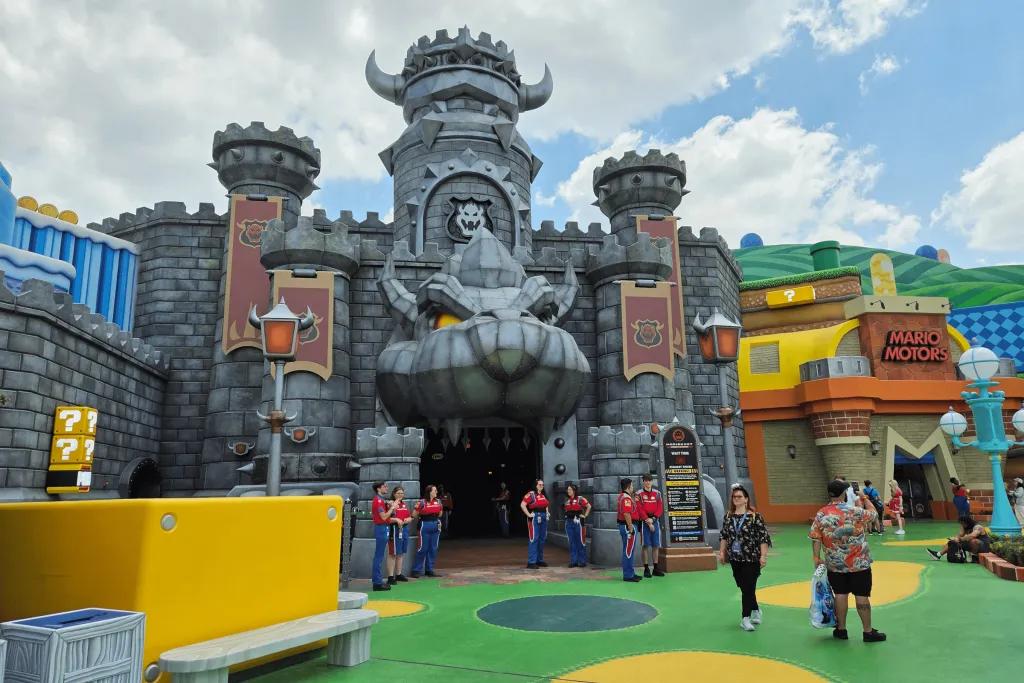 Super Nintendo World Themed land just like Super Nintendo with red, yellow, green and blue videogame style elements and a grey building in the middle with creature mouth opening as the entrance.