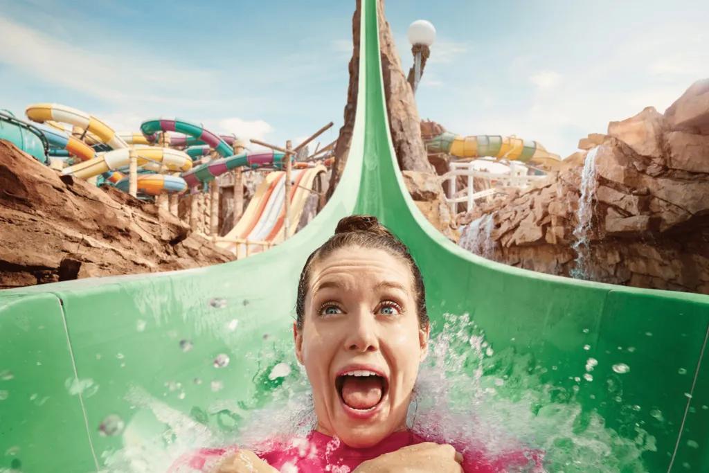 Jebel Drop Woman screaming on a water slide which has a sheer drop.