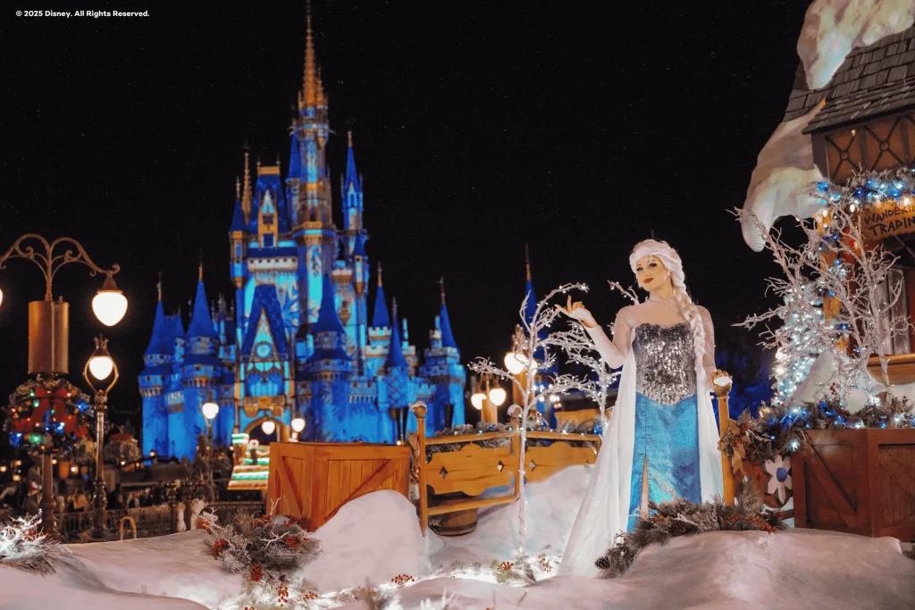 Mickey's Once Upon a Christmas Parade Elsa on a Christmas parade float in front of Cinderella Castle