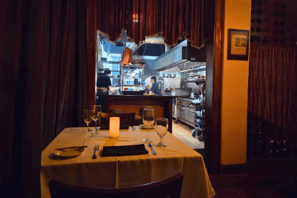 The Chef's Table A table set for dinner located next to an open kitchen