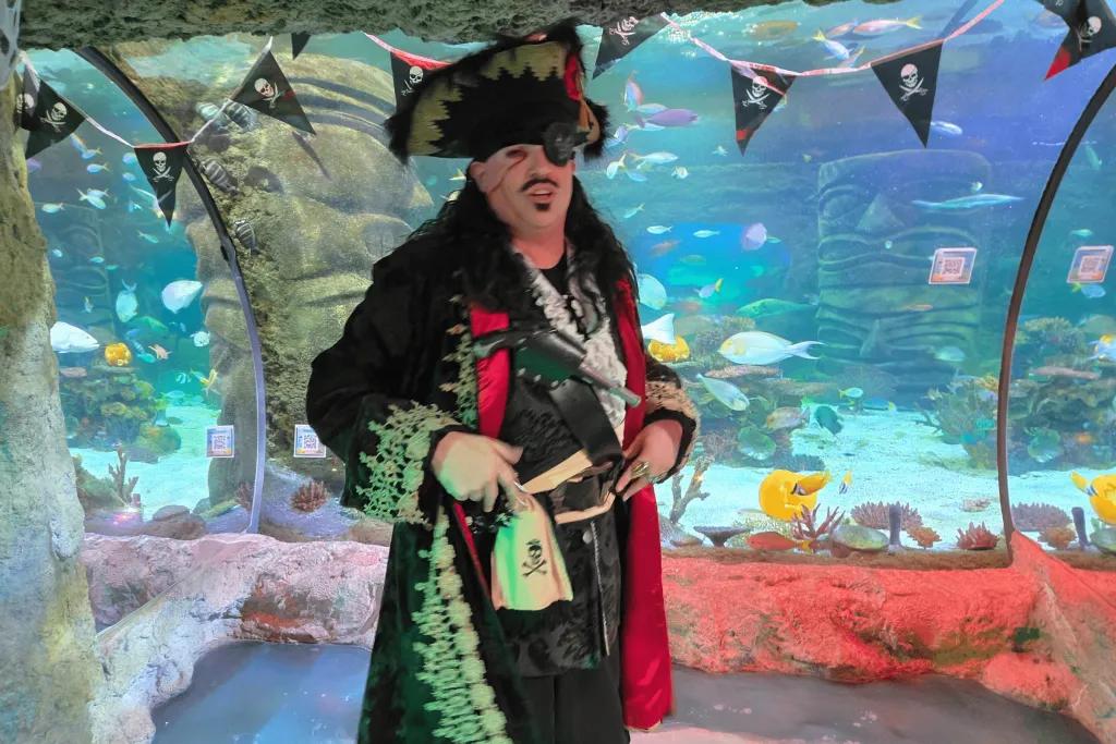 Pirate at SEA LIFE Man dressed as pirate in front of the aquarium glass view points.