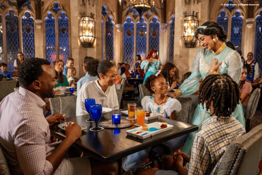 Guests smiling during a Character Dining experience as Princess Jasmine interacts with a family, showcasing a premium Walt Disney World dining option perfect for young children and families.