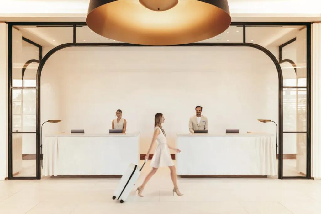 Woman walking through a clean lobby with white sleek design